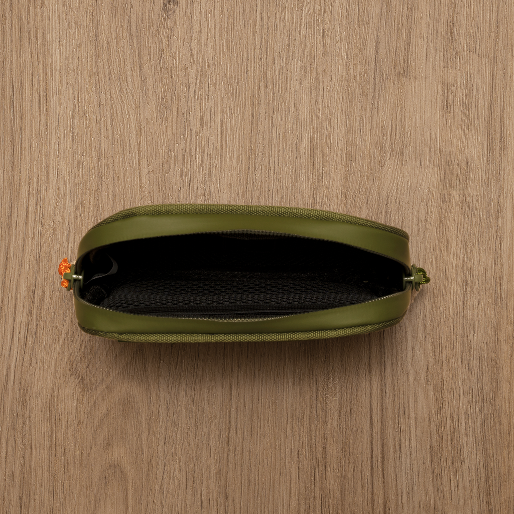 Green pouch with a zipper on a wooden surface