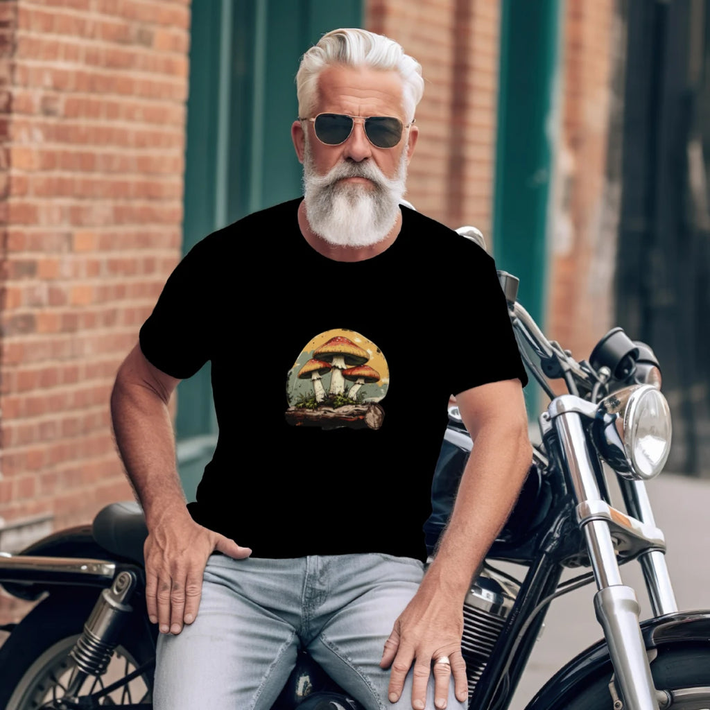 Man sitting on a motorcycle wearing a black t-shirt with a graphic design.