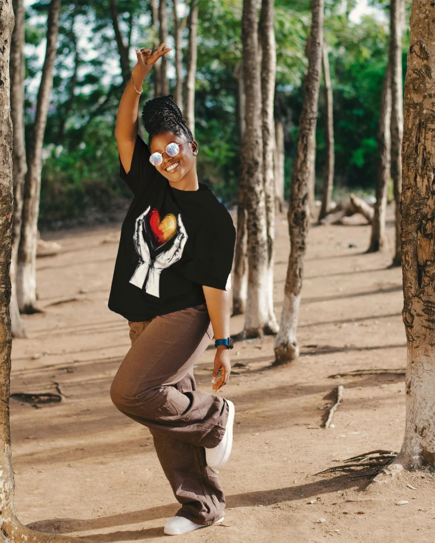 Person dancing in a forest with trees and natural light