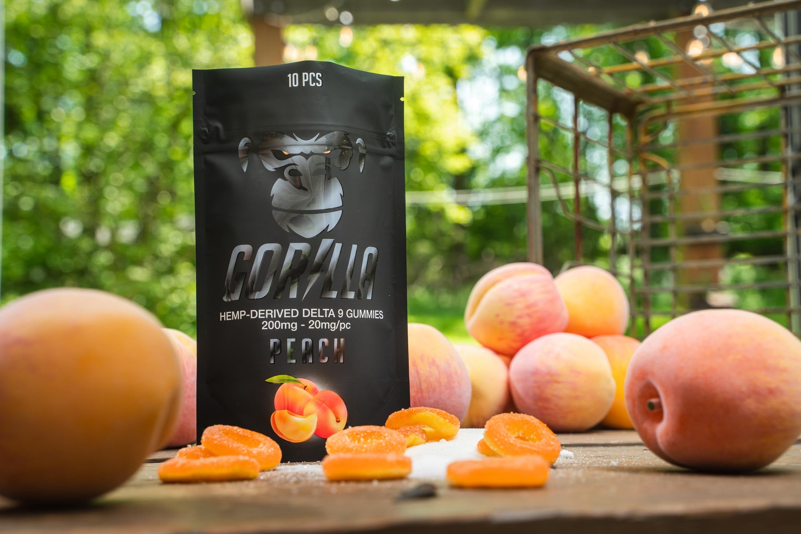 Gorilla Fresh cannabis product packaging with dried apricots on a wooden table outdoors.