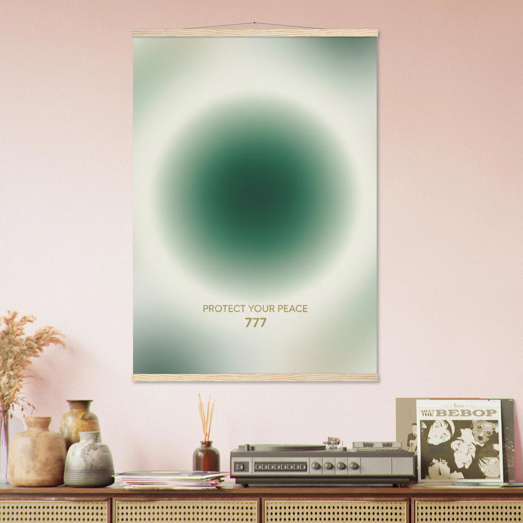Poster with a green circular design and text on a pink wall above a wooden shelf with decorative items.