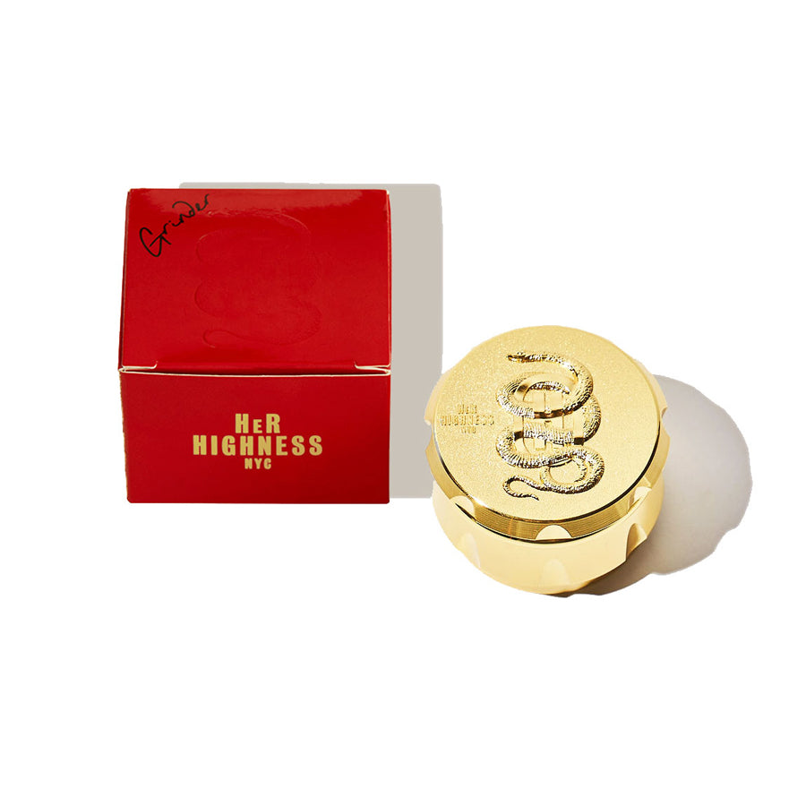 Gold cosmetic compact with 'Her Highness NYC' branding on a white background