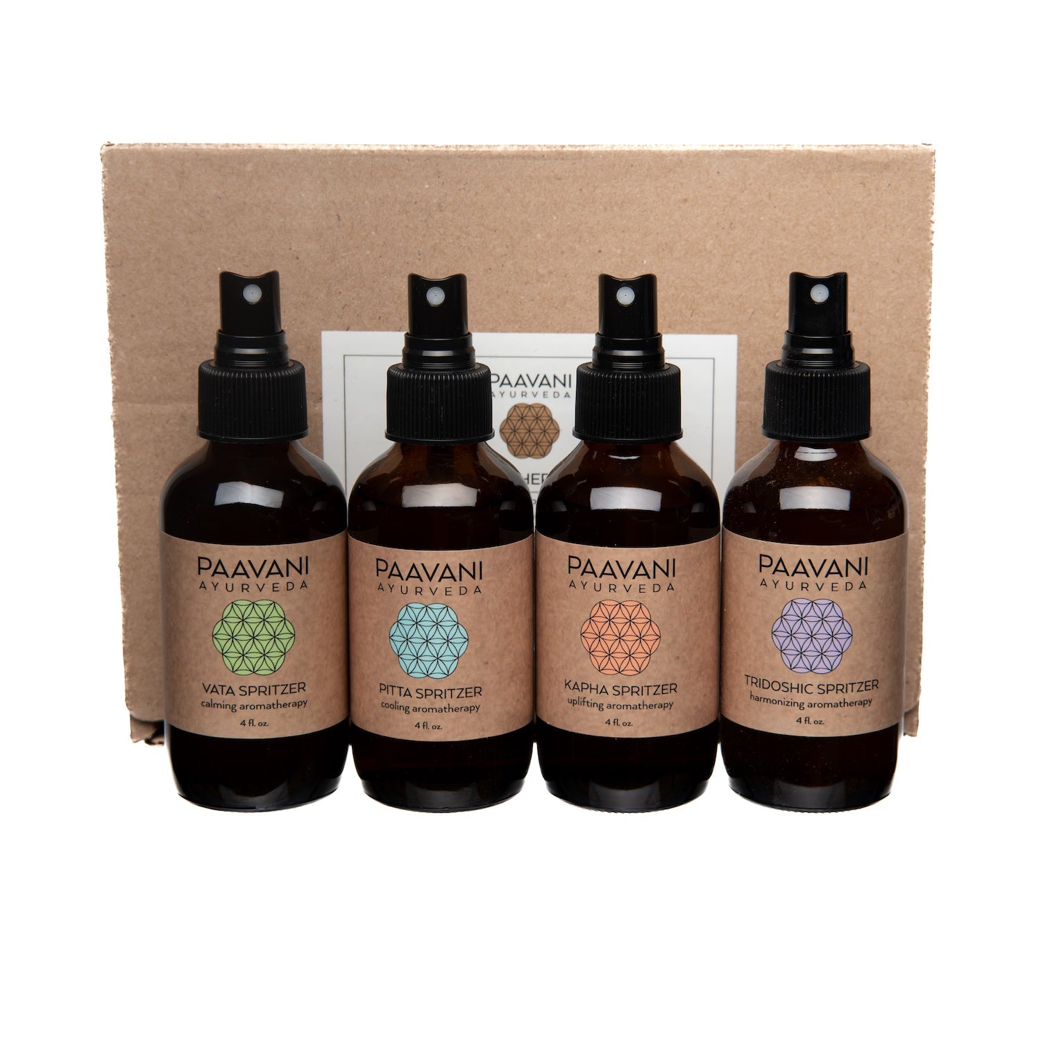 Four bottles of Paavani Ayurveda spritzers on a cardboard box background