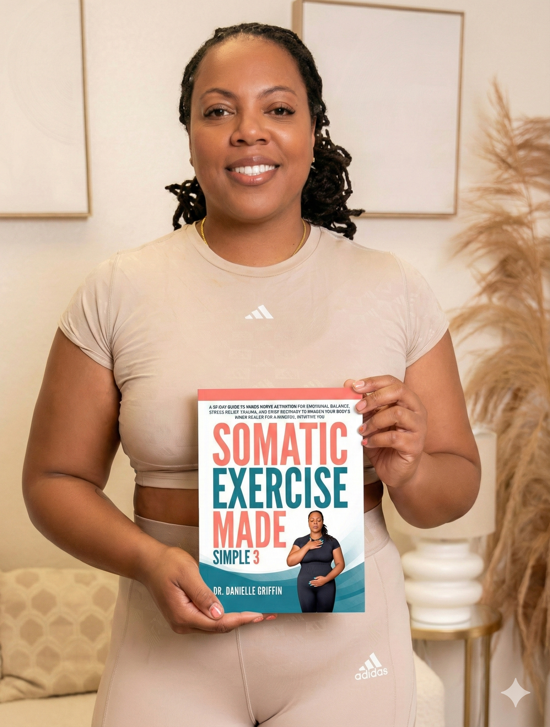 Woman holding a book titled 'Somatic Exercise Made Simple 3' in a casual setting.