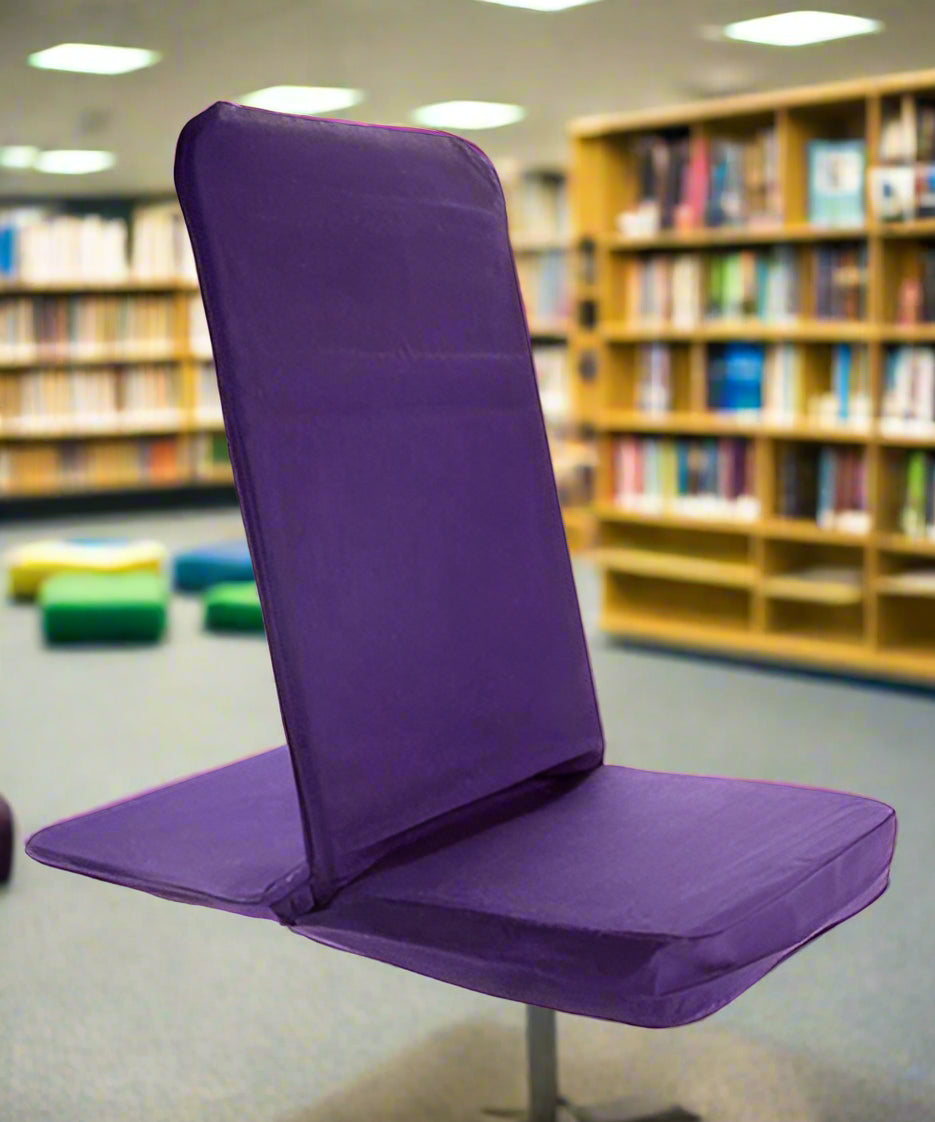 Purple folding chair in a library setting with bookshelves in the background