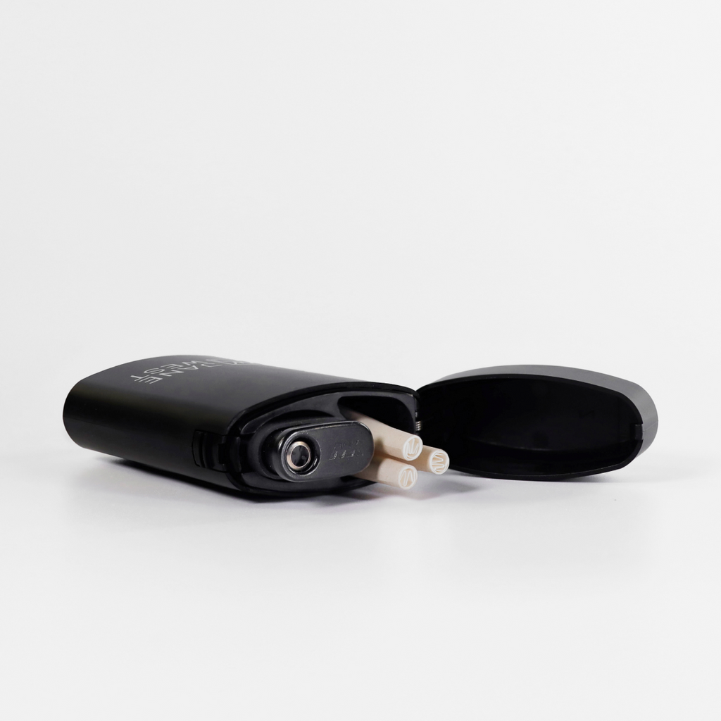 Black electronic device with cylindrical components on a white background