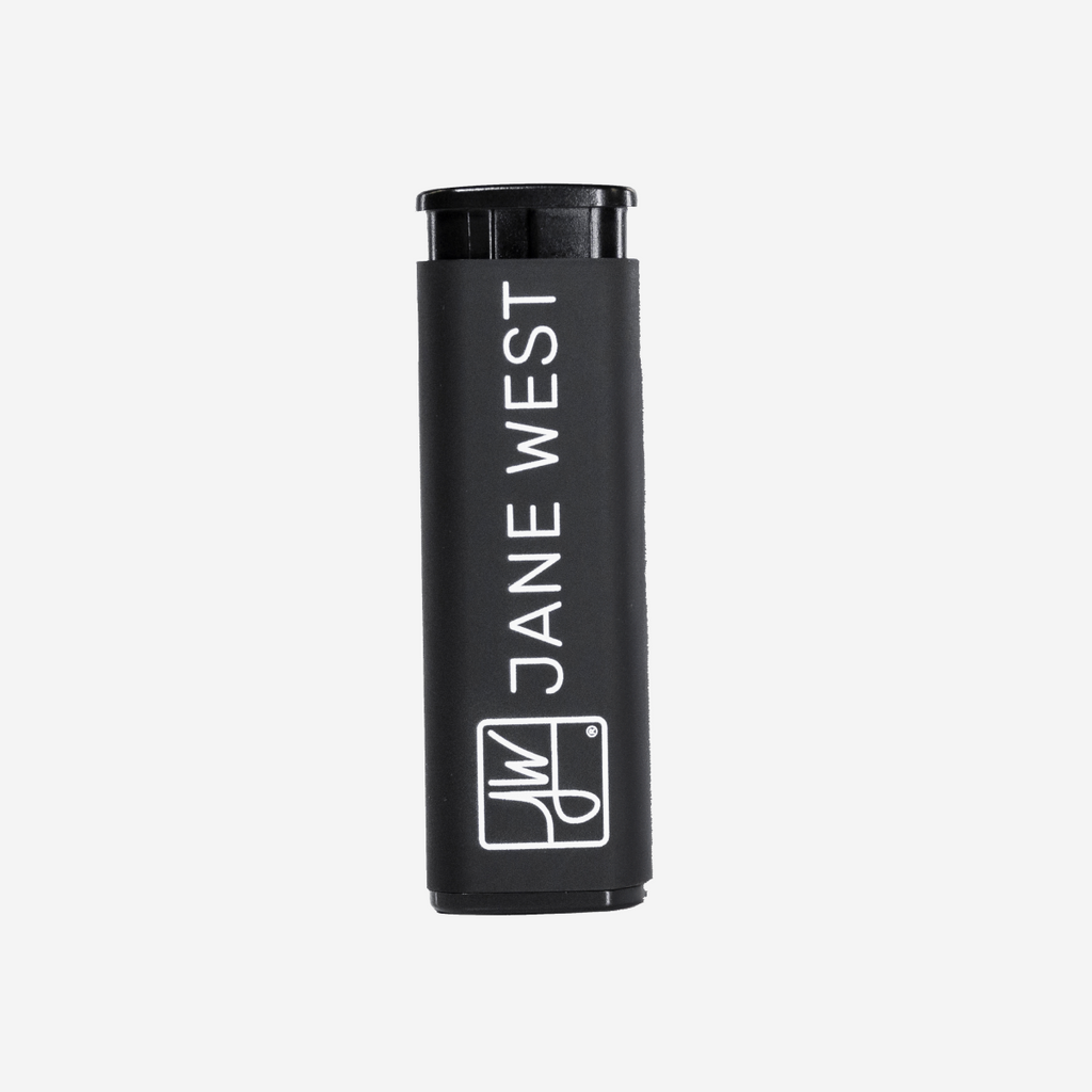 Black cylindrical container with 'Jane West' branding on a light gray background