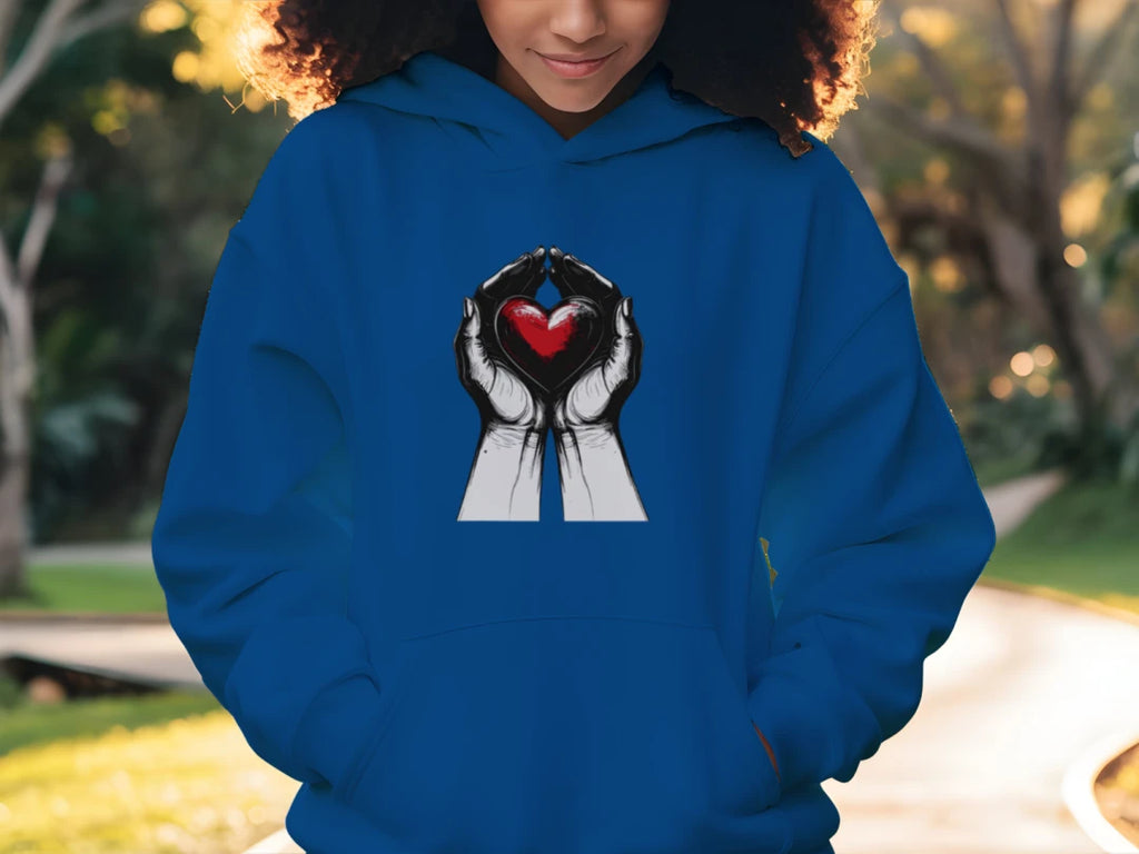 Person wearing a blue hoodie with a heart design outdoors