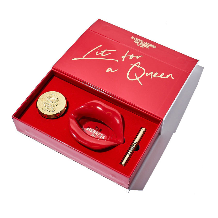 Red gift box with 'Lit for a Queen' text, containing a red lighter and gold coin, on a white background.