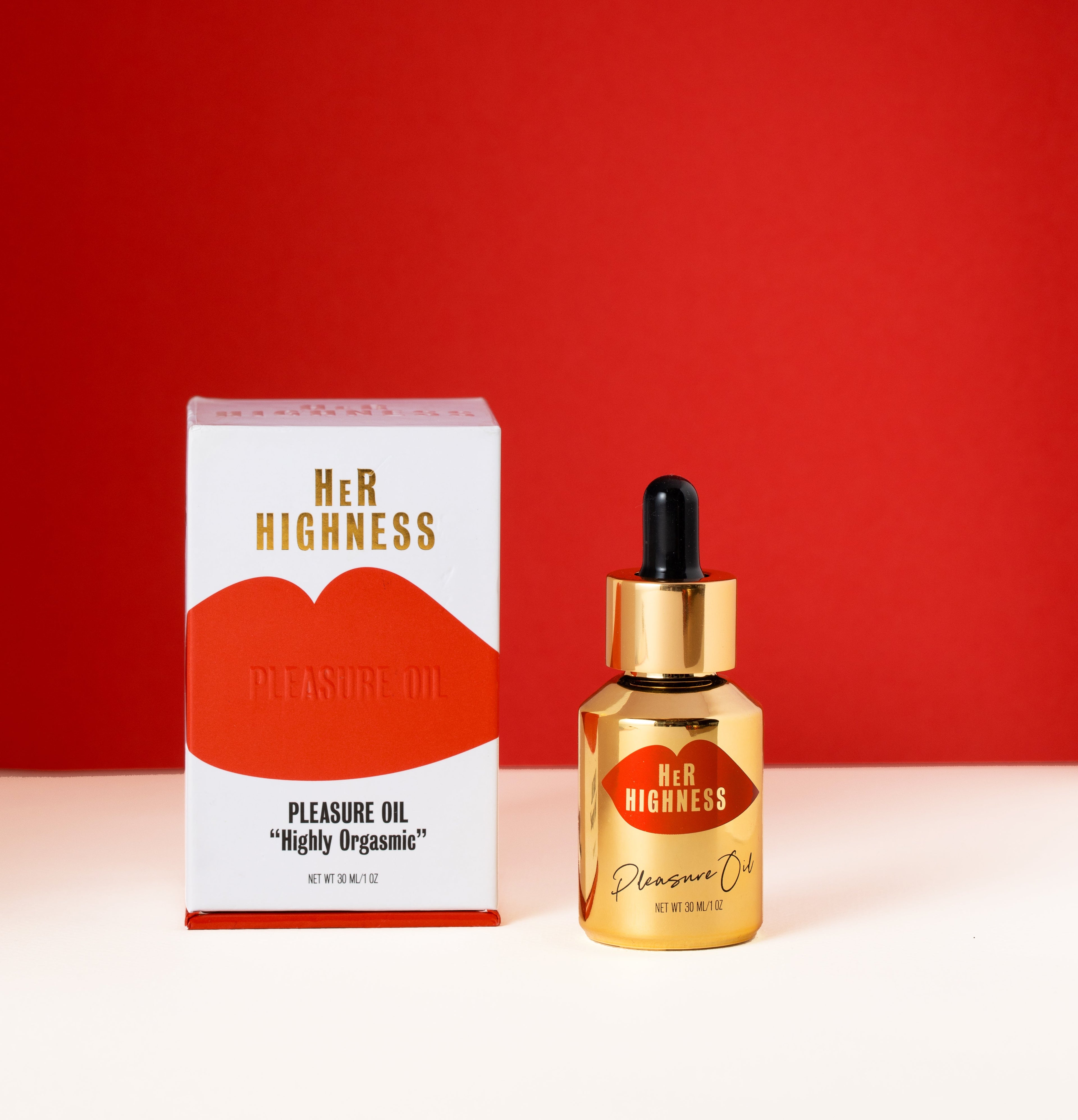 Her Highness Pleasure Oil packaging and bottle on a red background