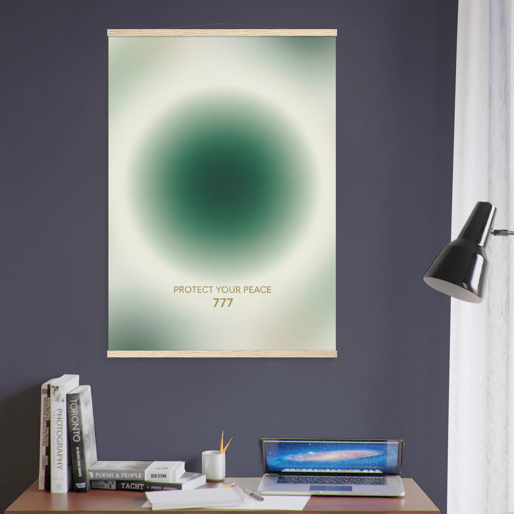 Poster with a green circular design on a dark purple wall above a desk with books and a laptop.