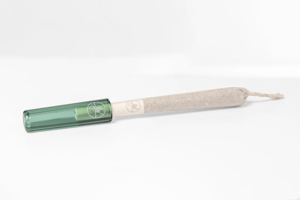 Roller with green handle and beige body on a white background