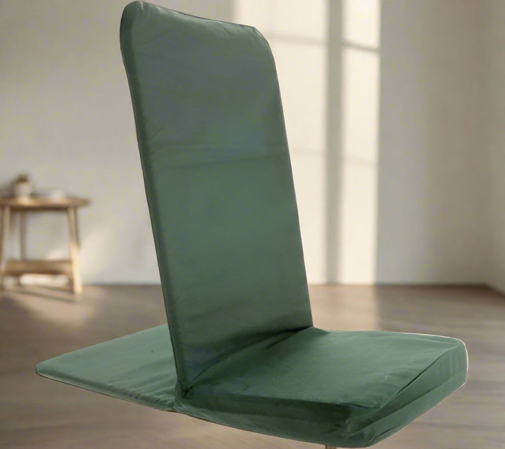 Green folding chair in a room with a wooden table and light-colored walls.