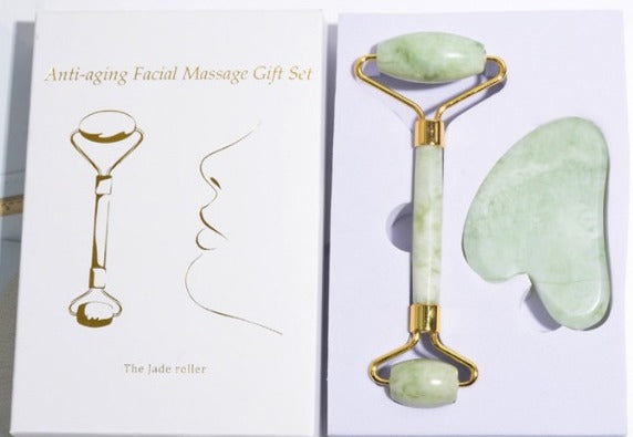 Anti-aging facial massage gift set with jade roller and gua sha tool on a white background